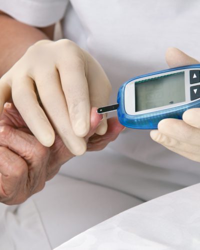 blood glucose meter. the blood sugar value is measured on a finger